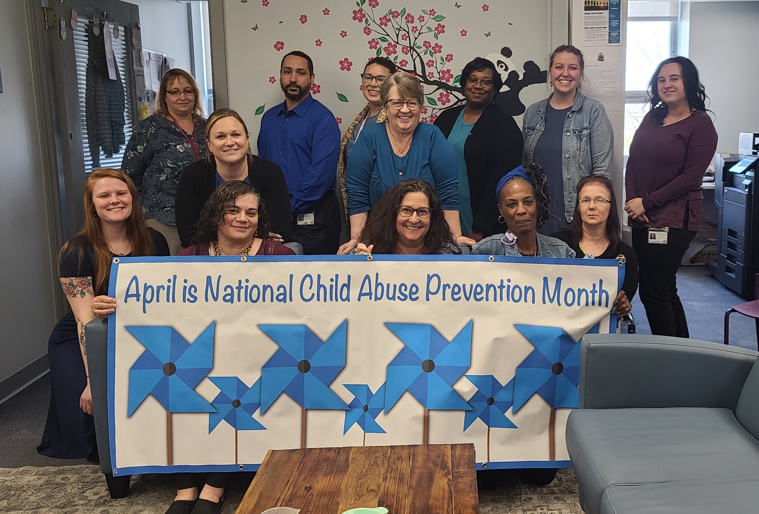 CYS Staff holding National Child Abuse Prevention Month Banner